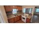Bright kitchen featuring wood cabinets, granite countertops, tile backsplash, and a gas range stove at 2880 W 91St Pl, Denver, CO 80260