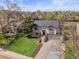 A beautiful elevated view showcasing this home with a well-manicured lawn, mature trees and attractive landscaping at 10895 W Bowles Pl, Littleton, CO 80127