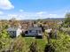 Aerial view of a backyard with deck showing the home's setting among mature trees and green spaces at 10895 W Bowles Pl, Littleton, CO 80127