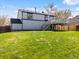 Home's backyard featuring a raised deck, green lawn, and privacy fencing at 10895 W Bowles Pl, Littleton, CO 80127