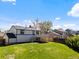 Expansive backyard featuring a well-maintained lawn and a charming deck area perfect for outdoor entertaining at 10895 W Bowles Pl, Littleton, CO 80127