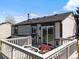 Backyard featuring a private deck, seating, and partial view of the home’s exterior at 10895 W Bowles Pl, Littleton, CO 80127