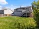 Lush backyard featuring a well-maintained lawn and deck area perfect for outdoor living and relaxation at 10895 W Bowles Pl, Littleton, CO 80127