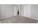 Bright bedroom with an open door and double door closet at 10895 W Bowles Pl, Littleton, CO 80127