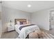 Neutral bedroom with a bed with brown accents and decorative stools on an eye-catching carpet at 10895 W Bowles Pl, Littleton, CO 80127