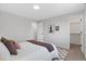 Neutral bedroom with a bed with brown accents and decorative stools on an eye-catching carpet at 10895 W Bowles Pl, Littleton, CO 80127