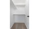 A walk-in closet with carpeted floors and white shelving and rails at 10895 W Bowles Pl, Littleton, CO 80127