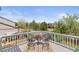 Cozy deck with modern seating, decorative flowers, and scenic views of the lush backyard at 10895 W Bowles Pl, Littleton, CO 80127