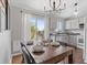 Cozy dining room featuring stylish lighting, slider to outside balcony, and updated appliances at 10895 W Bowles Pl, Littleton, CO 80127