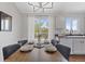 Inviting dining area with modern chandelier, seating for six, and slider access to outside balcony at 10895 W Bowles Pl, Littleton, CO 80127