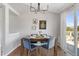 Bright dining area with modern light fixture, seating for four, and slider access to outside balcony at 10895 W Bowles Pl, Littleton, CO 80127