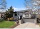 Charming two-story home featuring stone accents, a two-car garage, and a well-maintained front yard at 10895 W Bowles Pl, Littleton, CO 80127