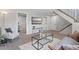 Spacious living room providing modern décor, cozy seating, a flatscreen TV, and access to multiple rooms at 10895 W Bowles Pl, Littleton, CO 80127