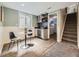 Finished basement with a kitchenette bar area, dining table, and stairs to the main level at 1350 E Amherst Ave, Englewood, CO 80113