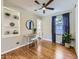 Charming bedroom with hardwood floors, built-in shelving, and desk for a cozy and functional space at 1350 E Amherst Ave, Englewood, CO 80113