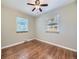 Inviting bedroom with hardwood floors, two windows with blinds, and neutral paint at 1350 E Amherst Ave, Englewood, CO 80113