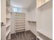 Walk-in closet with ample shelving provides organized storage solutions at 1350 E Amherst Ave, Englewood, CO 80113