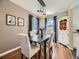 Cozy dining room with modern lighting, neutral decor, and hardwood floors at 1350 E Amherst Ave, Englewood, CO 80113