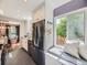Well-lit kitchen with white cabinets, subway tile, granite counters, and adjacent dining area at 1350 E Amherst Ave, Englewood, CO 80113