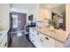 Modern kitchen featuring white cabinets, granite countertops, and stainless steel appliances at 1350 E Amherst Ave, Englewood, CO 80113