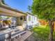 Inviting outdoor space with a covered patio, comfortable seating, and well-manicured lawn at 1350 E Amherst Ave, Englewood, CO 80113