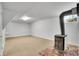 Cozy finished basement area featuring wood burning stove and ample space at 7819 Tejon St, Denver, CO 80221