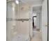 Updated basement bathroom with glass shower, and tile floor, view into hallway at 7819 Tejon St, Denver, CO 80221
