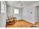 Light bedroom featuring hardwood floors, neutral walls, and two windows with a ceiling fan at 7819 Tejon St, Denver, CO 80221