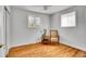Bright bedroom with hardwood floors, two windows, and neutral paint, ready for personalization at 7819 Tejon St, Denver, CO 80221