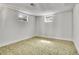 Finished basement bedroom with neutral carpet and two egress windows at 7819 Tejon St, Denver, CO 80221
