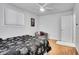 Bright bedroom with hardwood floors features a gray chair and natural light from a window with blinds at 7819 Tejon St, Denver, CO 80221