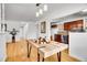 Inviting dining area with bamboo floors offering views to a modern kitchen at 7819 Tejon St, Denver, CO 80221