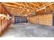 Unfinished garage with exposed framing, two car bays and storage shelves at 7819 Tejon St, Denver, CO 80221