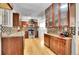 Stylish kitchen showcasing dark cabinetry, mosaic tile backsplash, and modern appliances at 7819 Tejon St, Denver, CO 80221
