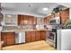 Updated kitchen with stainless steel appliances, ample counter space, and warm wood cabinetry at 7819 Tejon St, Denver, CO 80221