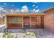 Covered patio with decorative latticework, a wooden deck, and a brick exterior, for relaxation at 7819 Tejon St, Denver, CO 80221