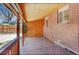 Relaxing wooden patio with brick siding and wood ceiling, offering a cozy outdoor space at 7819 Tejon St, Denver, CO 80221