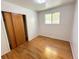 A bedroom with hardwood floors, closet storage, and a window that allows ample natural light at 660 Wolff St, Denver, CO 80204