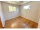 Cozy bedroom features hardwood floors and natural light from two windows at 660 Wolff St, Denver, CO 80204