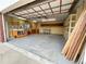 A well-lit garage with work space, shelving units and bright lighting at 660 Wolff St, Denver, CO 80204
