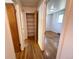 A hallway with wood floors, built in storage, and doors leading to rooms at 660 Wolff St, Denver, CO 80204