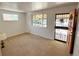 Bright living room with fresh paint, carpet flooring, and two windows that allow ample natural light at 660 Wolff St, Denver, CO 80204