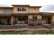 Backyard featuring a covered patio with seating, rock features, and well-maintained lawn at 12254 Hazel Spruce Ct, Parker, CO 80134
