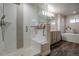 Bright bathroom featuring a large shower with built-in bench next to a soaking tub and double vanity at 12254 Hazel Spruce Ct, Parker, CO 80134