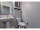 Modern half bathroom with a stylish sink and toilet for guests at 12254 Hazel Spruce Ct, Parker, CO 80134