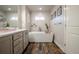 Soaking tub in a modern bathroom with wood-style floors and contemporary fixtures at 12254 Hazel Spruce Ct, Parker, CO 80134
