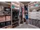 Organized walk-in closet with custom shelving for clothing, shoes, and accessories at 12254 Hazel Spruce Ct, Parker, CO 80134