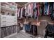 A well-organized walk-in closet featuring ample hanging space, drawers, and shelving at 12254 Hazel Spruce Ct, Parker, CO 80134
