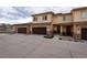 Attractive townhome exterior highlighting a brown garage door and well-maintained landscaping at 12254 Hazel Spruce Ct, Parker, CO 80134