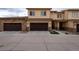 Inviting townhome exterior showcasing stone accents, a brown garage door, and well-maintained landscaping at 12254 Hazel Spruce Ct, Parker, CO 80134